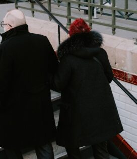a couple of people that are standing on some stairs